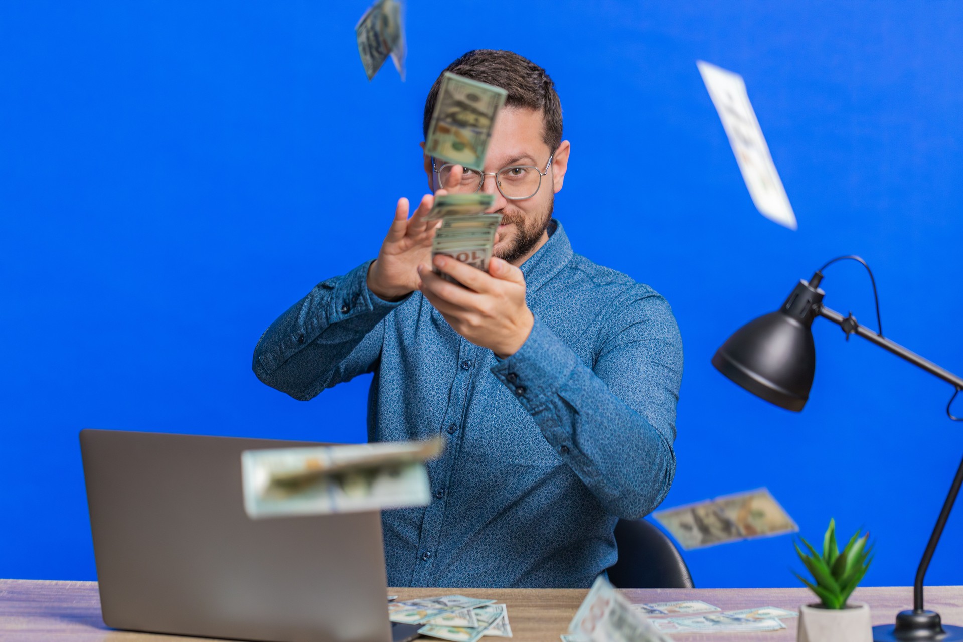 man throwing money around
